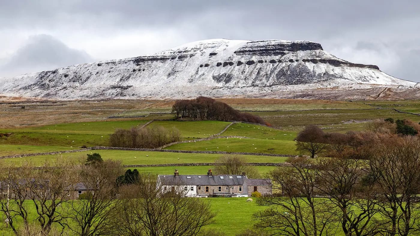 Pen-y-Ghent under snow above a Ribblesdale farm