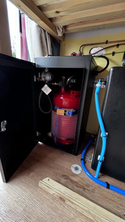An LPG gas bottle installed in a campervan gas locker