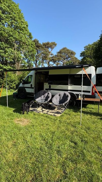 A campervan with its awning pitched