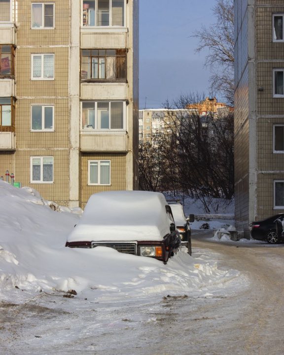 A campervan-style vehicle parked in deep winter snow